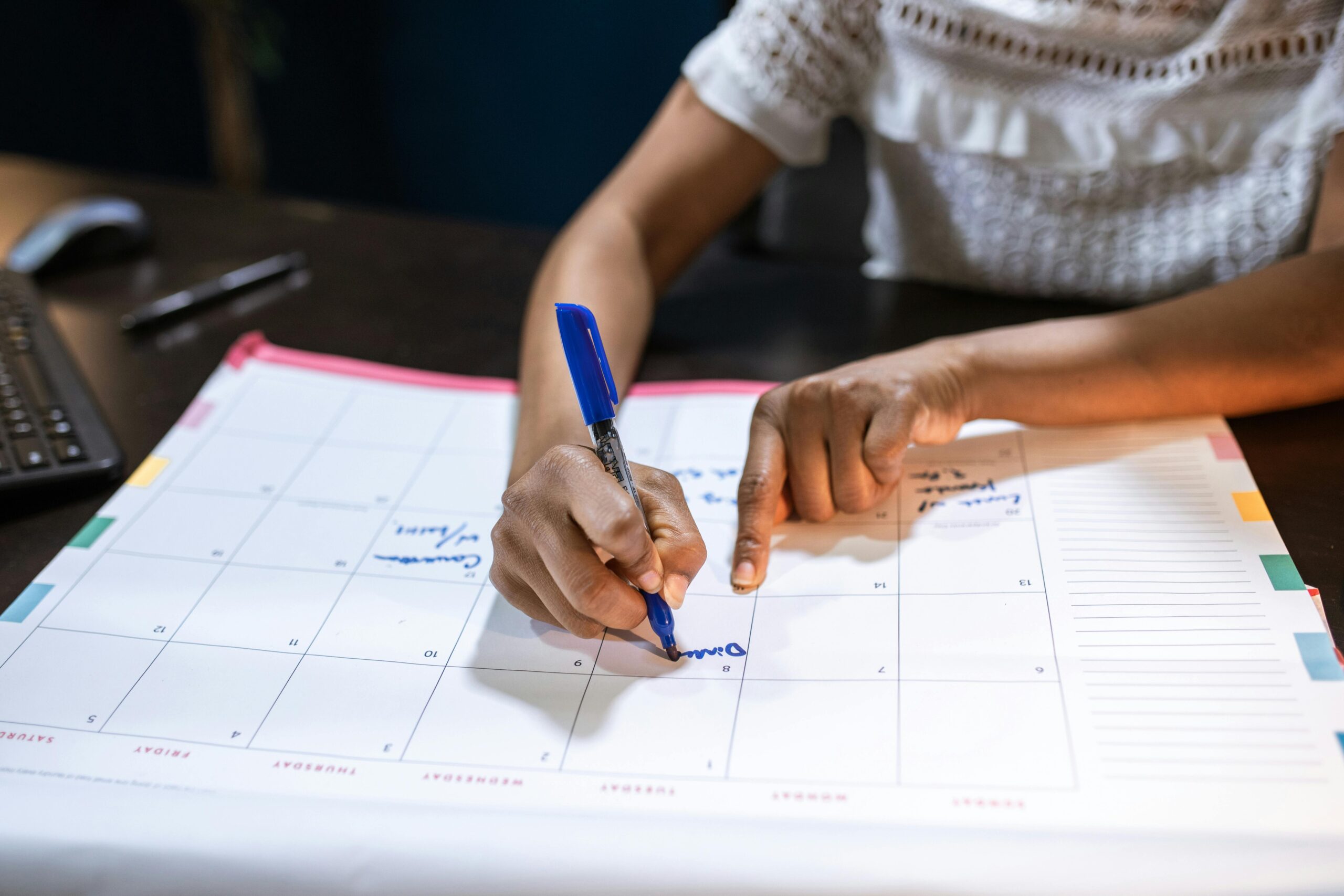 Person marking EMI repayment due date on calendar to avoid late fees — GetLoanCredit tip