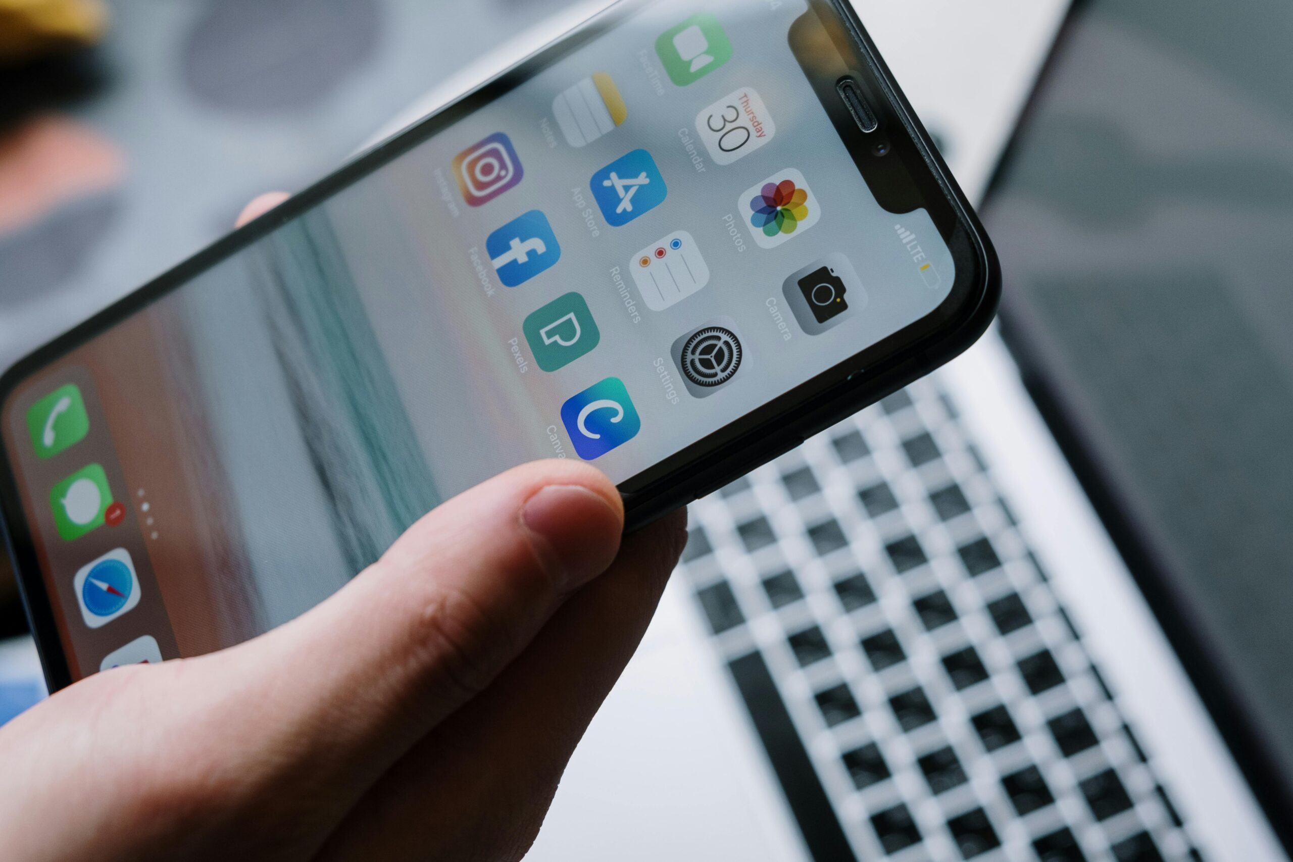 Person holding a smartphone with app icons — choosing a trustworthy loan app in India