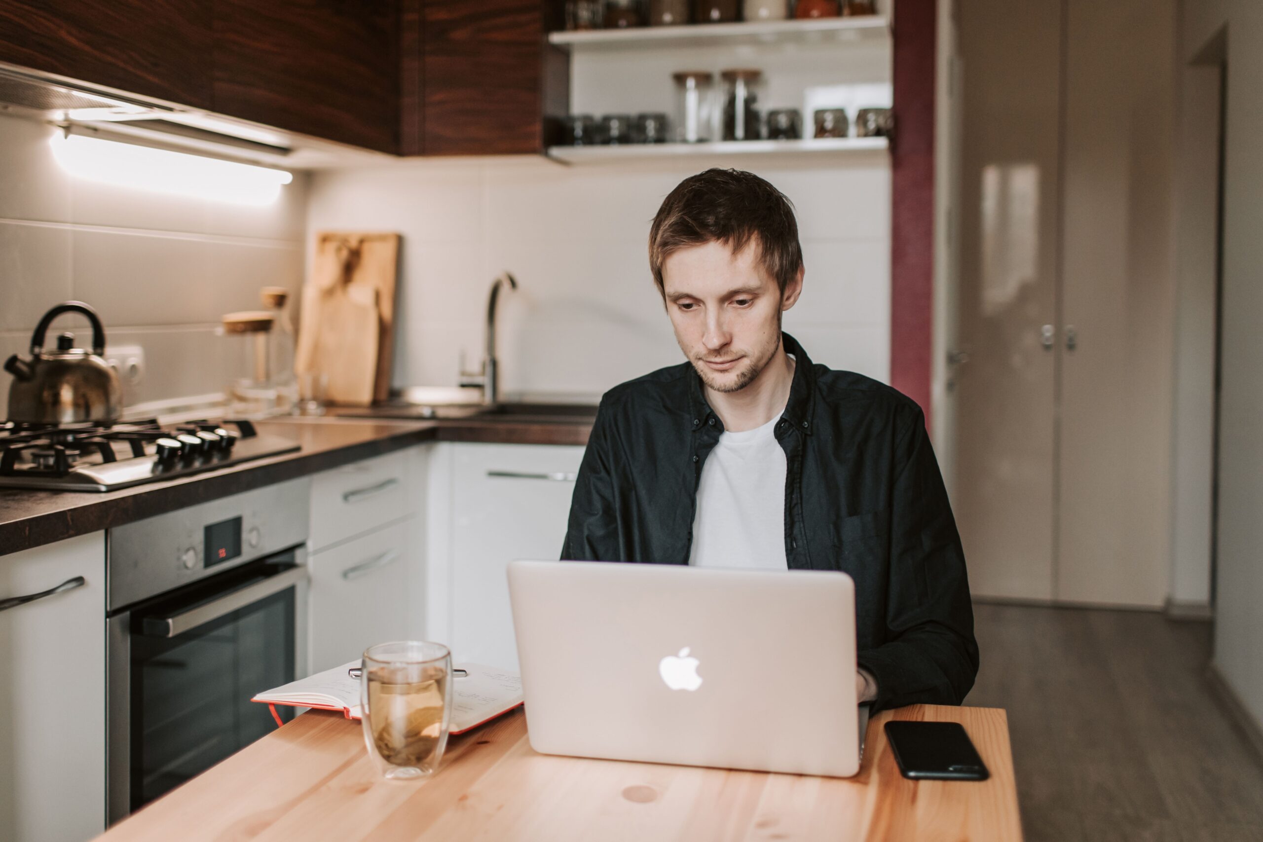 Man calmly working at laptop — taking deliberate steps to resolve a loan repayment problem in India