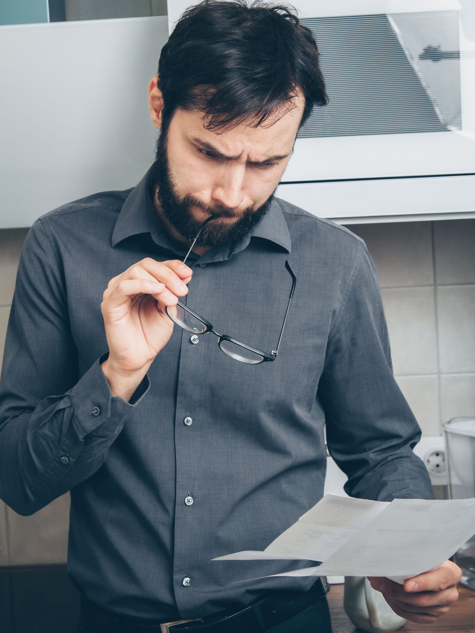 Man calmly reviewing documents and making a plan to rebuild his CIBIL score from 650 in India
