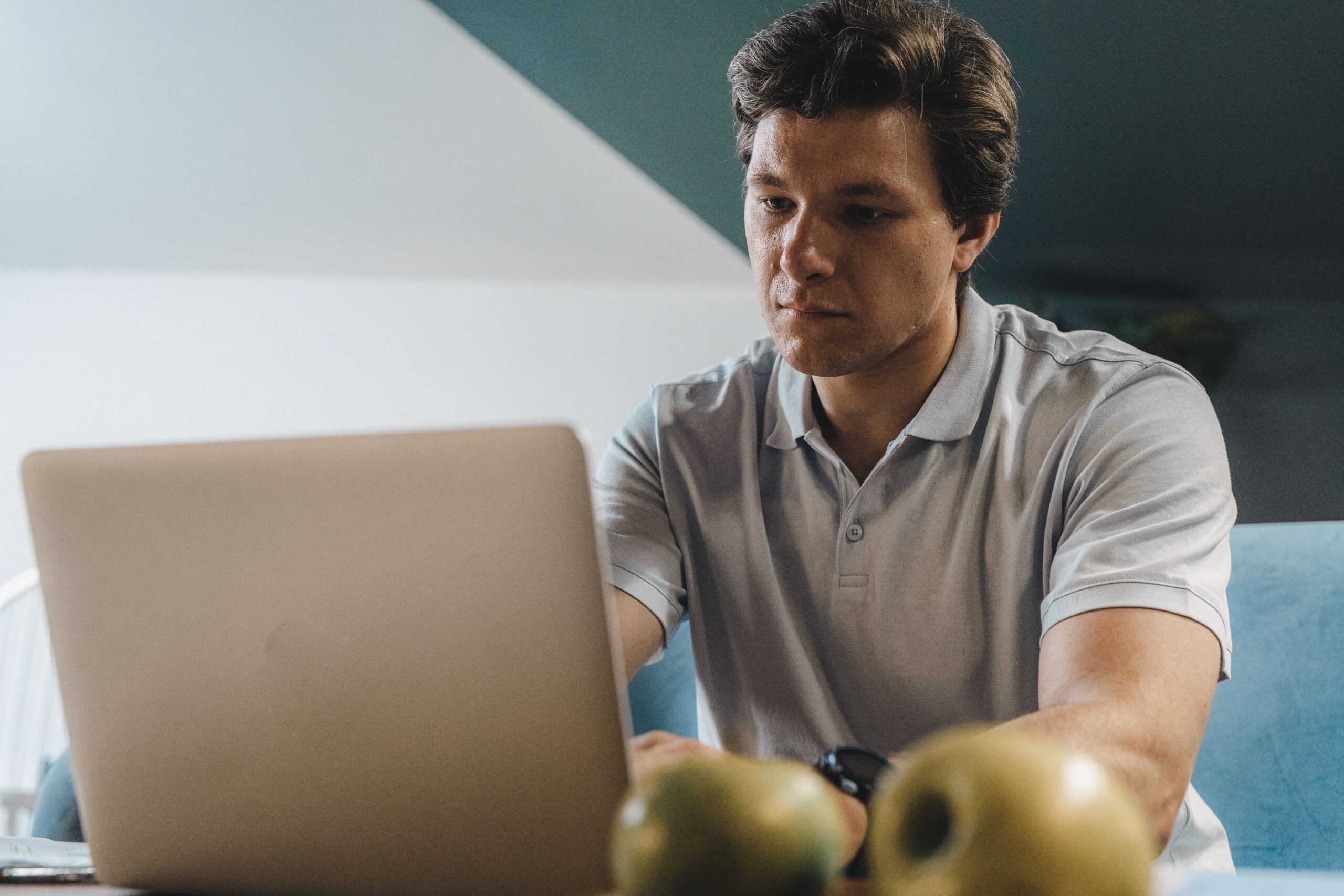 Self-employed man working confidently on laptop after finding a suitable loan app in India